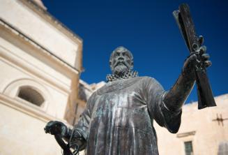 Malta'da bir parşömeni bulunan bir adamın heykeli